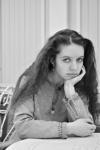 Portrait of young woman sitting at home