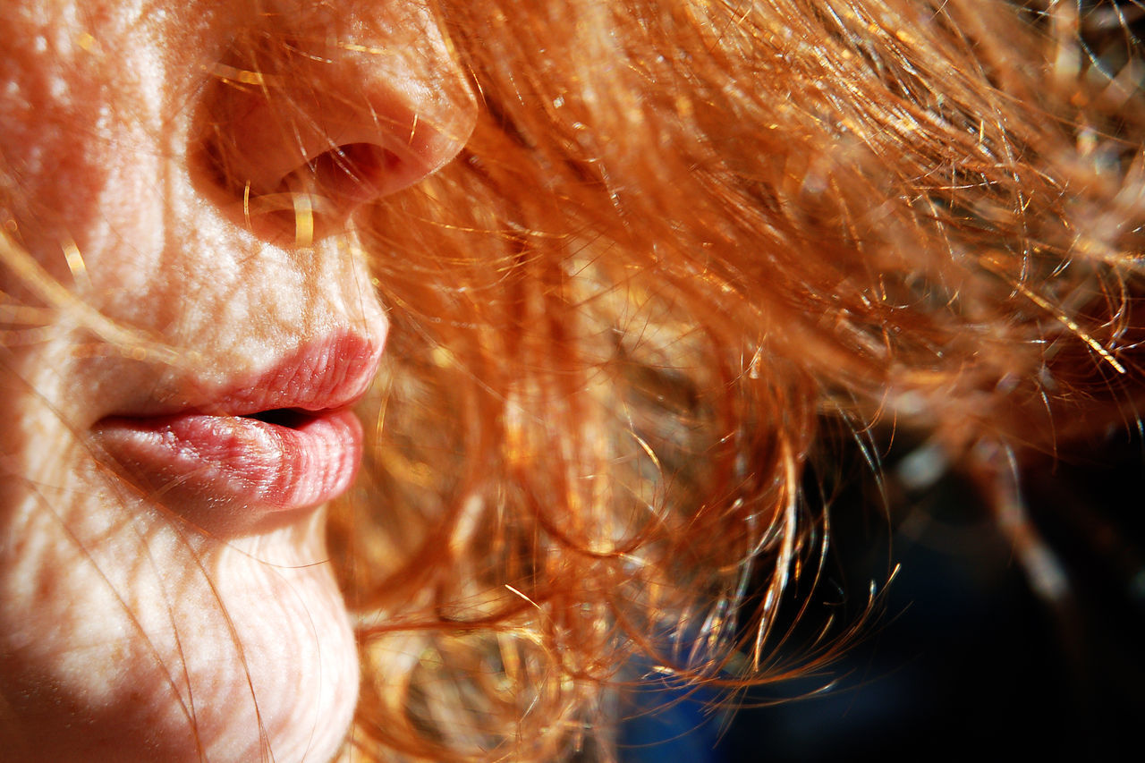 Cropped image of woman blowing hair