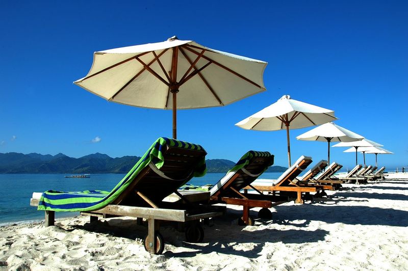 Lounge chair and beach umbrellas on beach