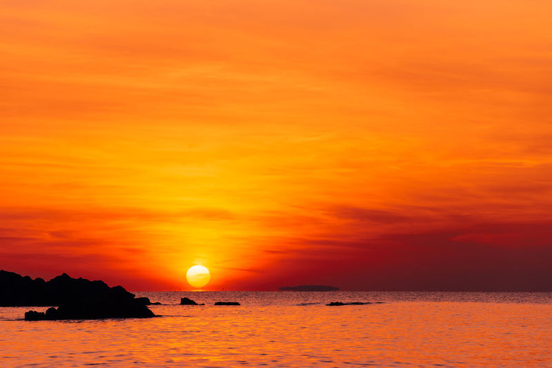 Scenic view of sea against romantic sky at sunset