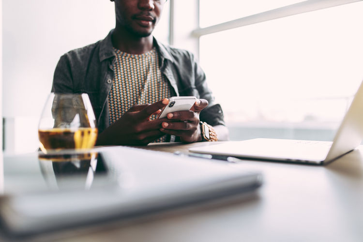 Business Cellphone Office Adult Business Businessman Communication Computer Connection Drink Indoors Laptop Phone Real People Selective Focus Sitting Table Technology Using Laptop Wireless Technology