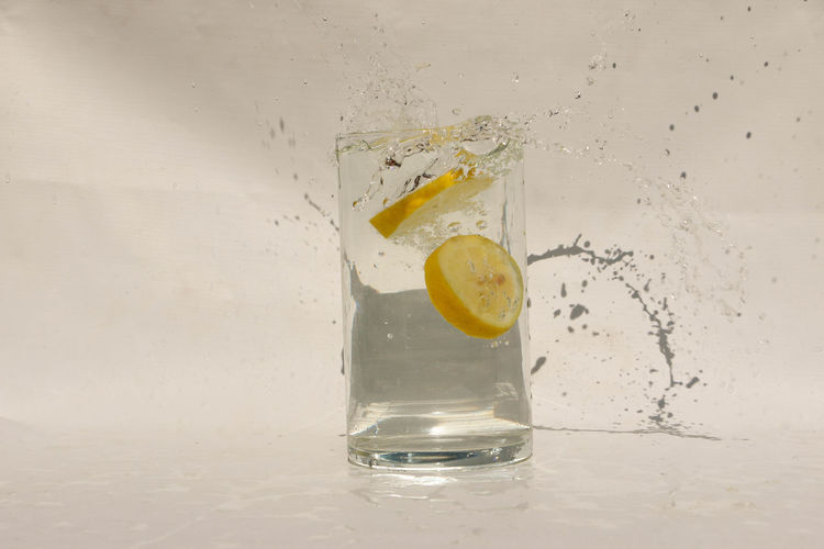 Close-up of drink on glass against white background
