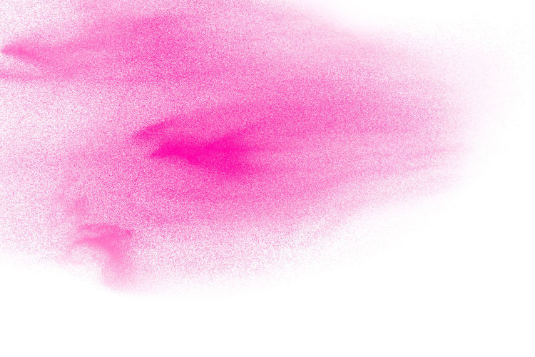 Defocused image of pink powder paint against white background