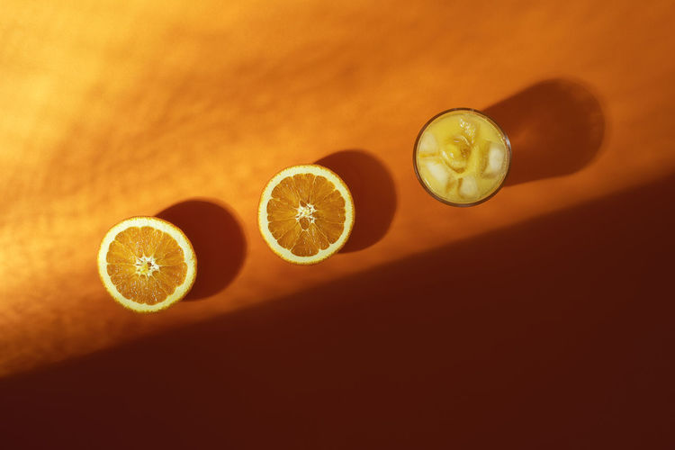 Close-up of oranges with drink on table