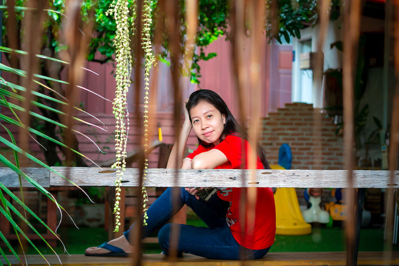 Portrait of smiling girl sitting outdoors