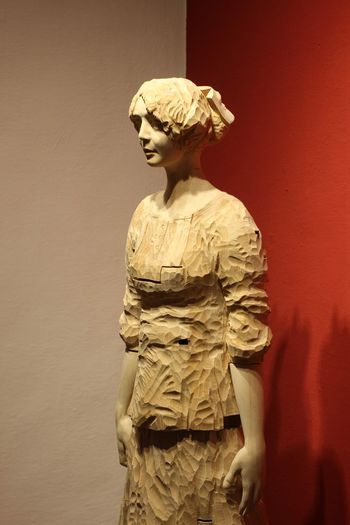 Statue of women against wall red 
