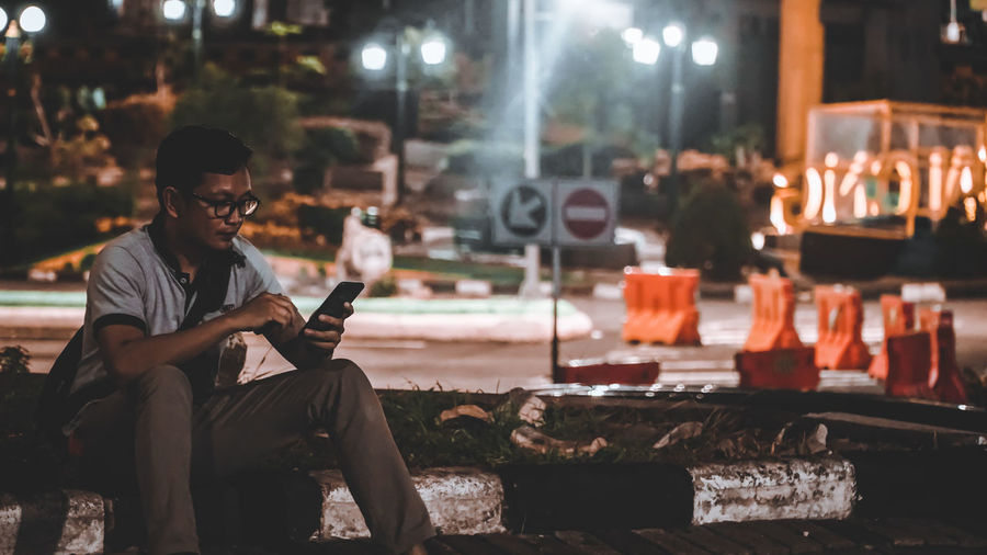 Man using mobile phone at night