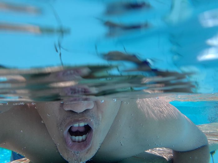 Close-up of man swimming in pool
