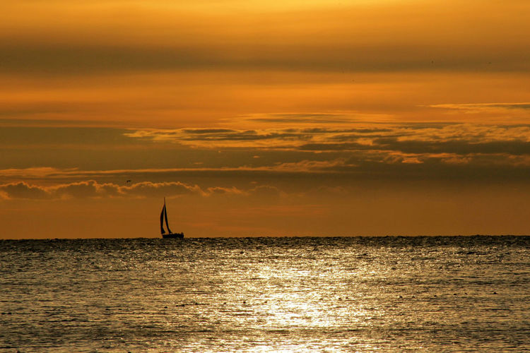 Lone boat in calm sea against the sky