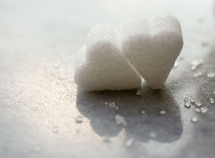 Close-up of heart shape sugar cubes on marble