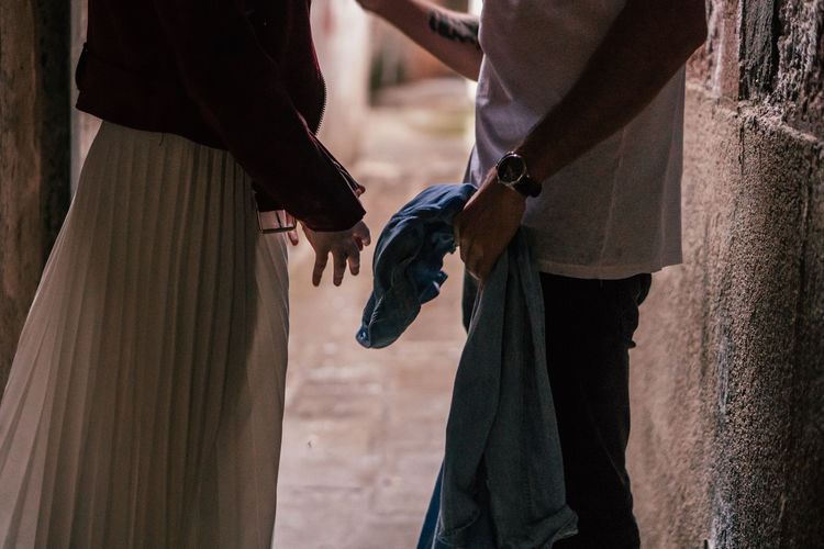 Midsection of couple standing outdoors