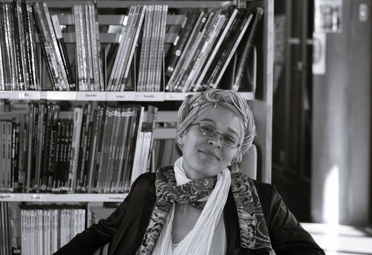 Portrait of smiling woman sitting in library