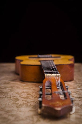Close-up of guitar on table