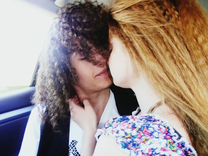Couple kissing while traveling in car