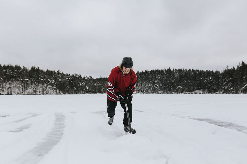 Man ice-skating on frozen lake