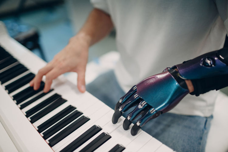Close-up of man playing piano