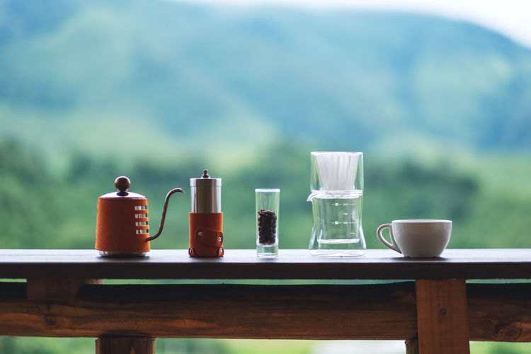 A set of coffee drip equipment with blurred nature background