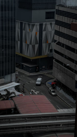 High angle view of cars on road against buildings