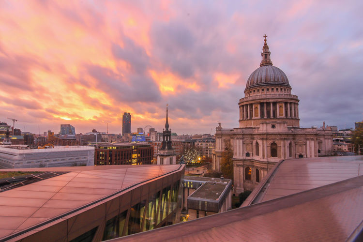 Buildings against cloudy sky