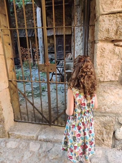 Rear view of girl standing at entrance