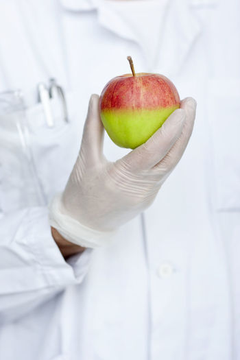 Laboratory technician holding apple
