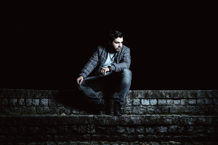 Young man sitting outdoors