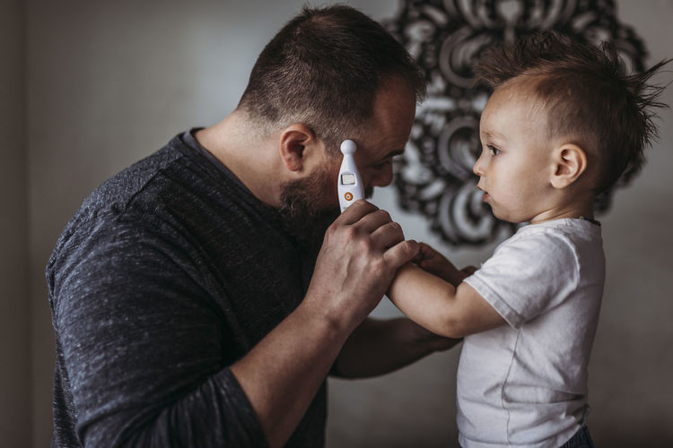 Portrait of boy holding father