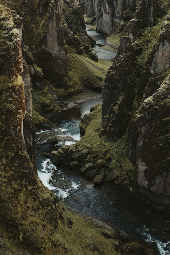 High angle view stream flowing through mountains