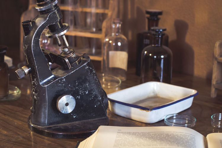 Antique laboratory microscope and glassware, selective focus. science and medical research concept