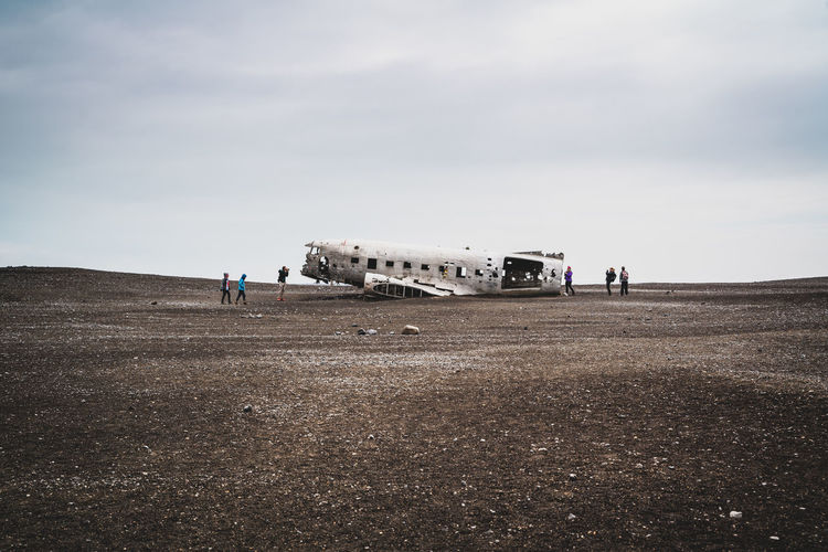 View of abandoned airplane on field against sky