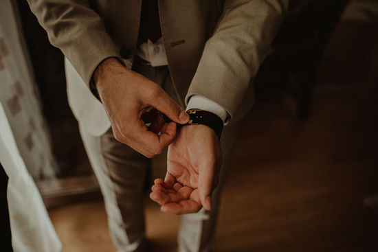 Midsection of bridegroom wearing wristwatch