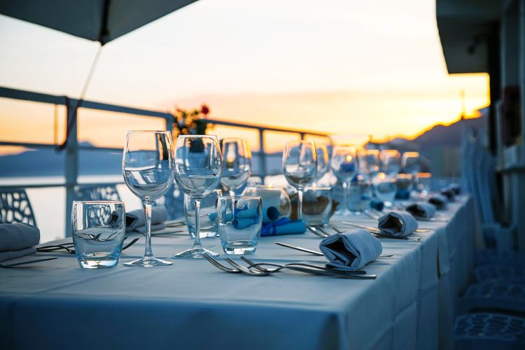 Chairs and tables in restaurant at sunset