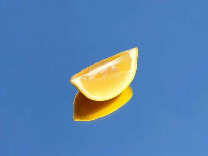 Close-up of lemon slice against blue background