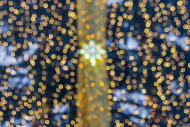 Full frame shot of defocused illuminated christmas tree at night
