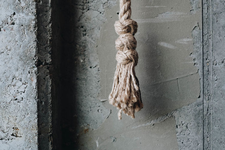 Close-up of rope hanging on wall