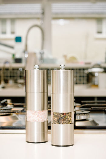 Close-up of salt and pepper shaker on table in kitchen