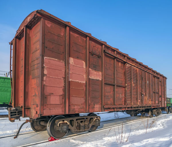 Red old, worn out boxcar of standard design on the rails on trans-siberian railway.