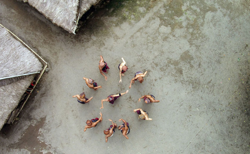 Directly above shot of people performing gegerok tandak dance on street