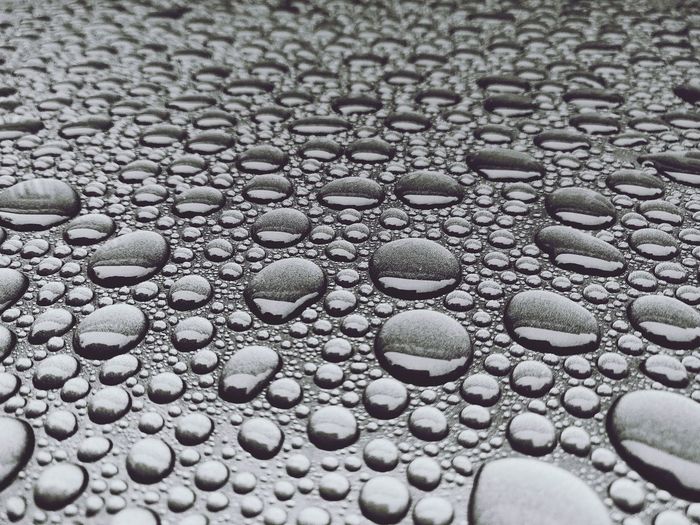 Full frame shot of raindrops on pebbles