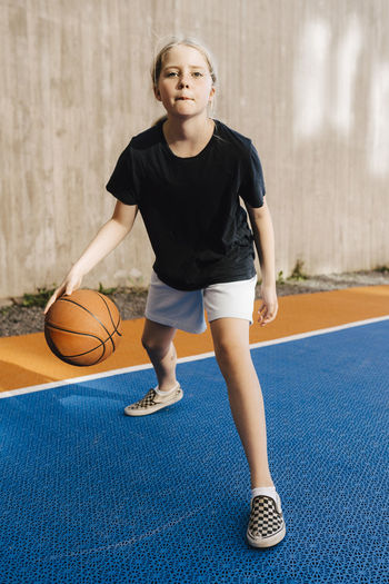 Portrait of boy playing with ball
