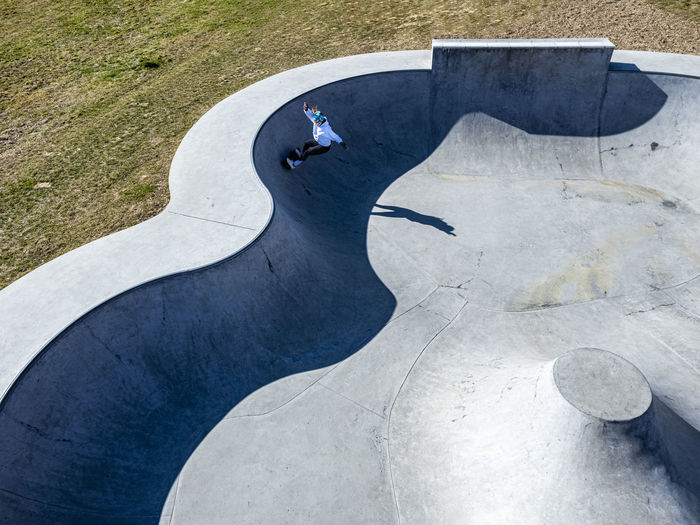 Young skateboarder practicing at pump track