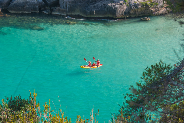 High angle view of people kayaking in sea