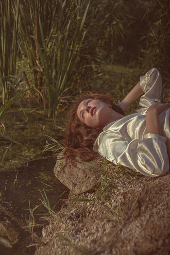 Portrait of woman lying down on land
