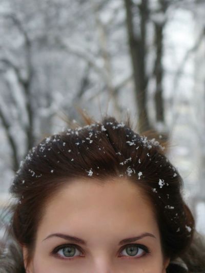 Close-up portrait of young woman with snow