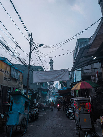 Cars on road against sky in city