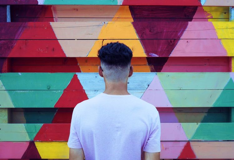 Man standing in front of multi colored wall