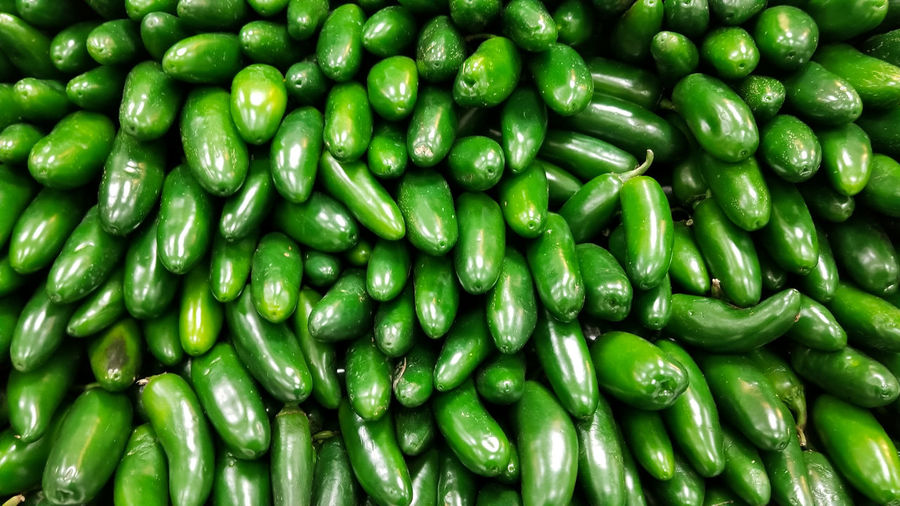 Full frame shot of green jalapeno peppers for sale at market
