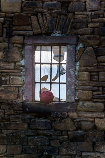 Low angle view of window on wall of old building