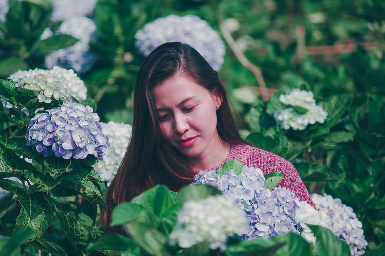 Smiling woman by flowering plants