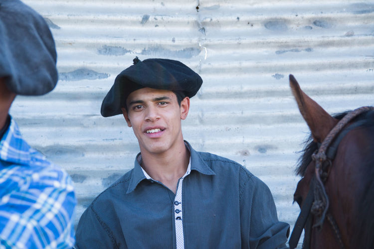 South american teenager wearing traditional flat cap